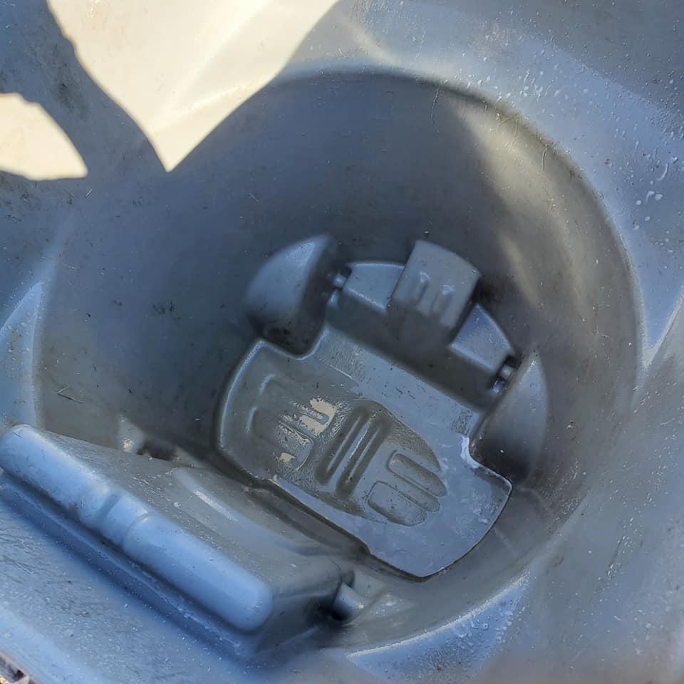 Outdoor trash area after cleanup and organization work.