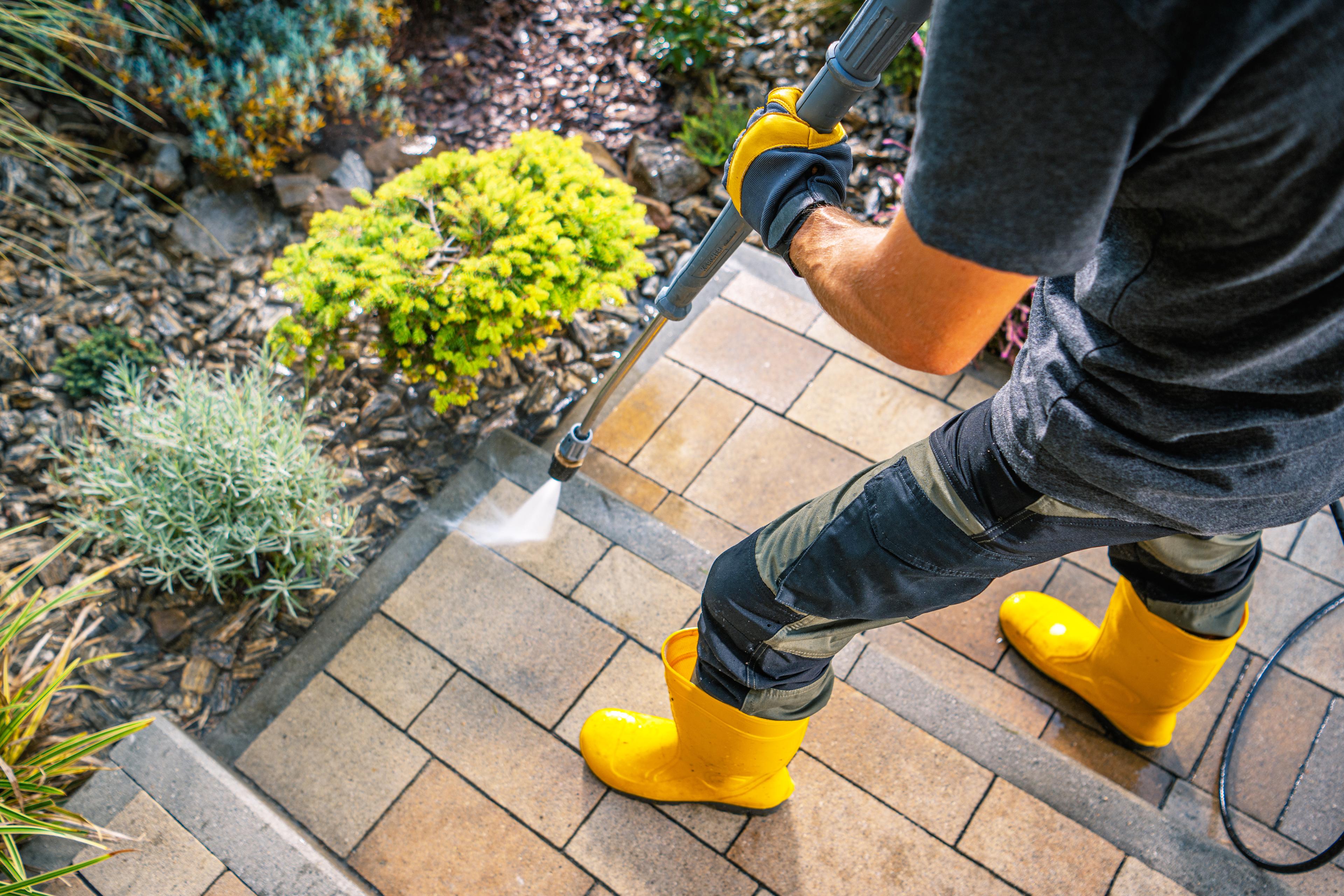 Pressure washer cleaning outdoor steps and detail edges.