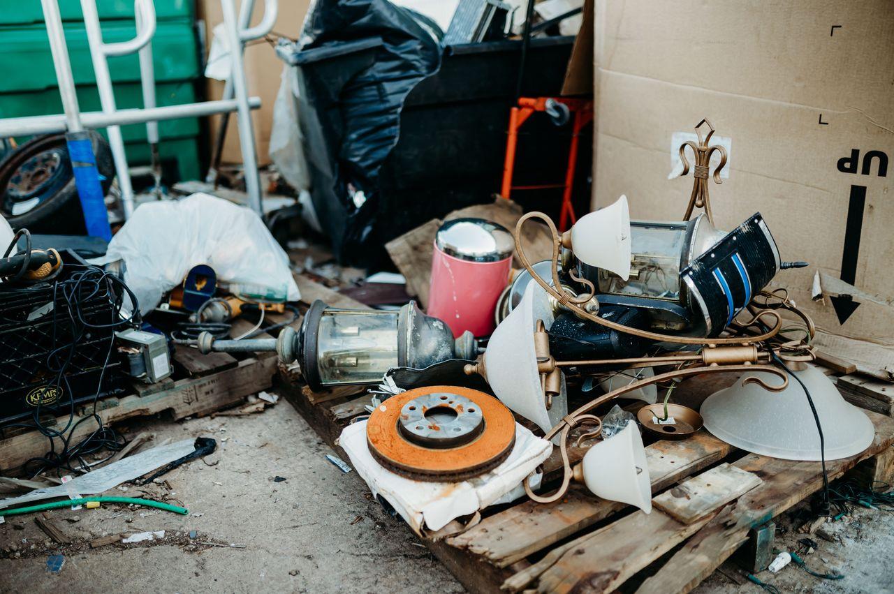 A large pile of debris being cleared from a residential property.