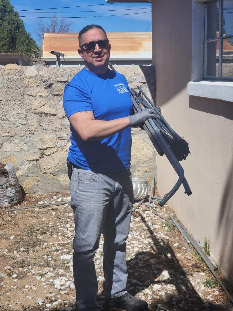 Wakala crew member holding reclaimed metal scrap.