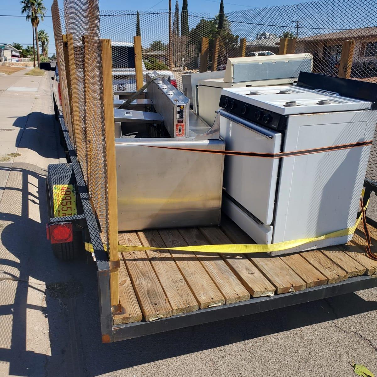Large unwanted appliances staged for removal and proper disposal.
